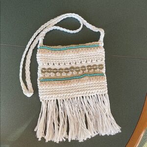 Crossbody purse with beads and shells .  100 percent cotton.